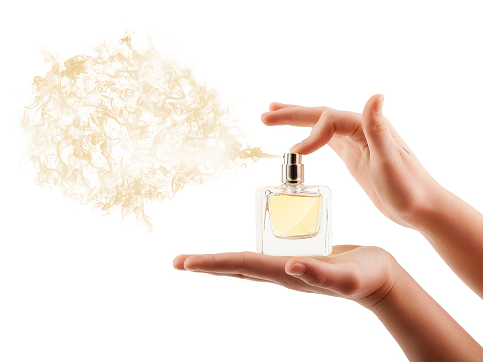 woman sprays perfume
